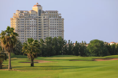 Fairway with trees and buildings in background