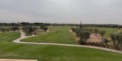 Tee box with palm trees to the side at Al Maaden Golf Course