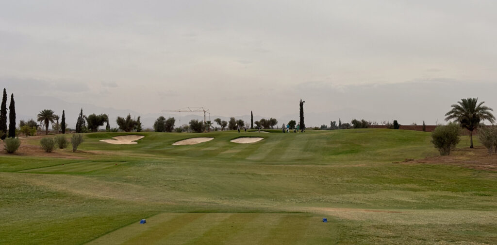 Tee box overlooking fairway with three bunkers at Al Maaden Golf Course
