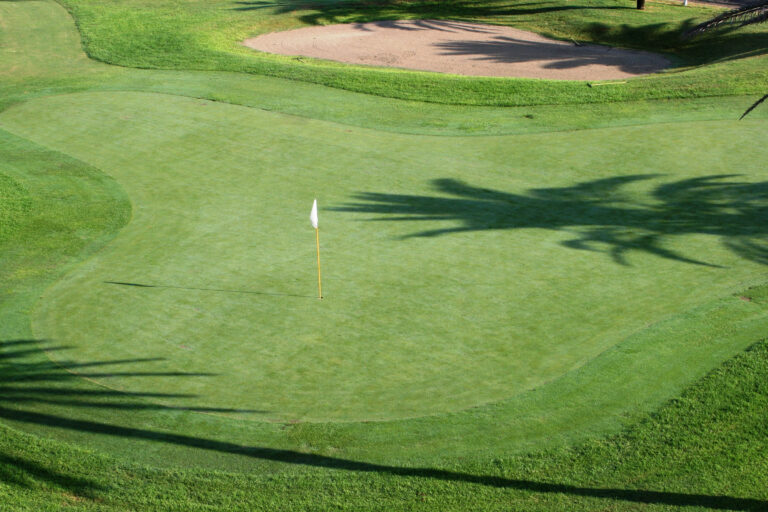 A hole with a white flag at Almerimar Golf Course