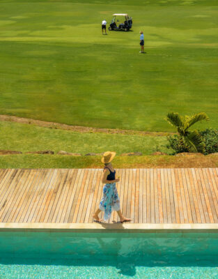 A guest strolling along the walkway around Anahita golf course