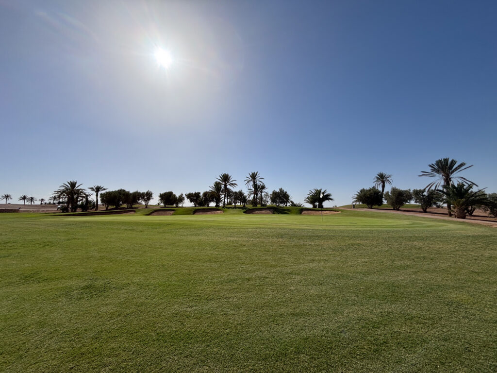 Greenside view with surrounding bunkers at Assoufid Golf Club