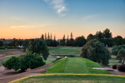 Tee box overlooking fairway with trees around at Benamor golf course