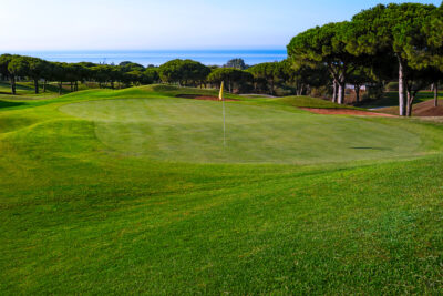 Hole with yellow flags at Cabopino Golf Course