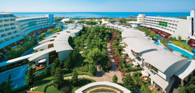 Overhead view of the resort, with the U shaped hotel wrapping around the gardens & pools below