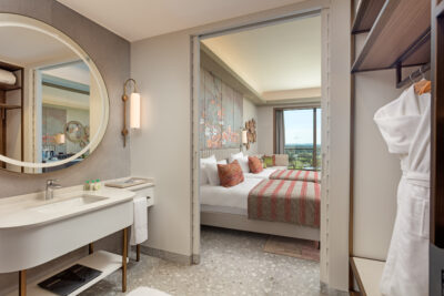 Hotel bedroom views from the bathroom looking towards the bed & balcony