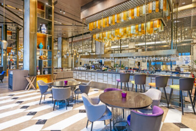 Restaurant & bar area of the hotel. The room is full with tables & chairs and a classy decor