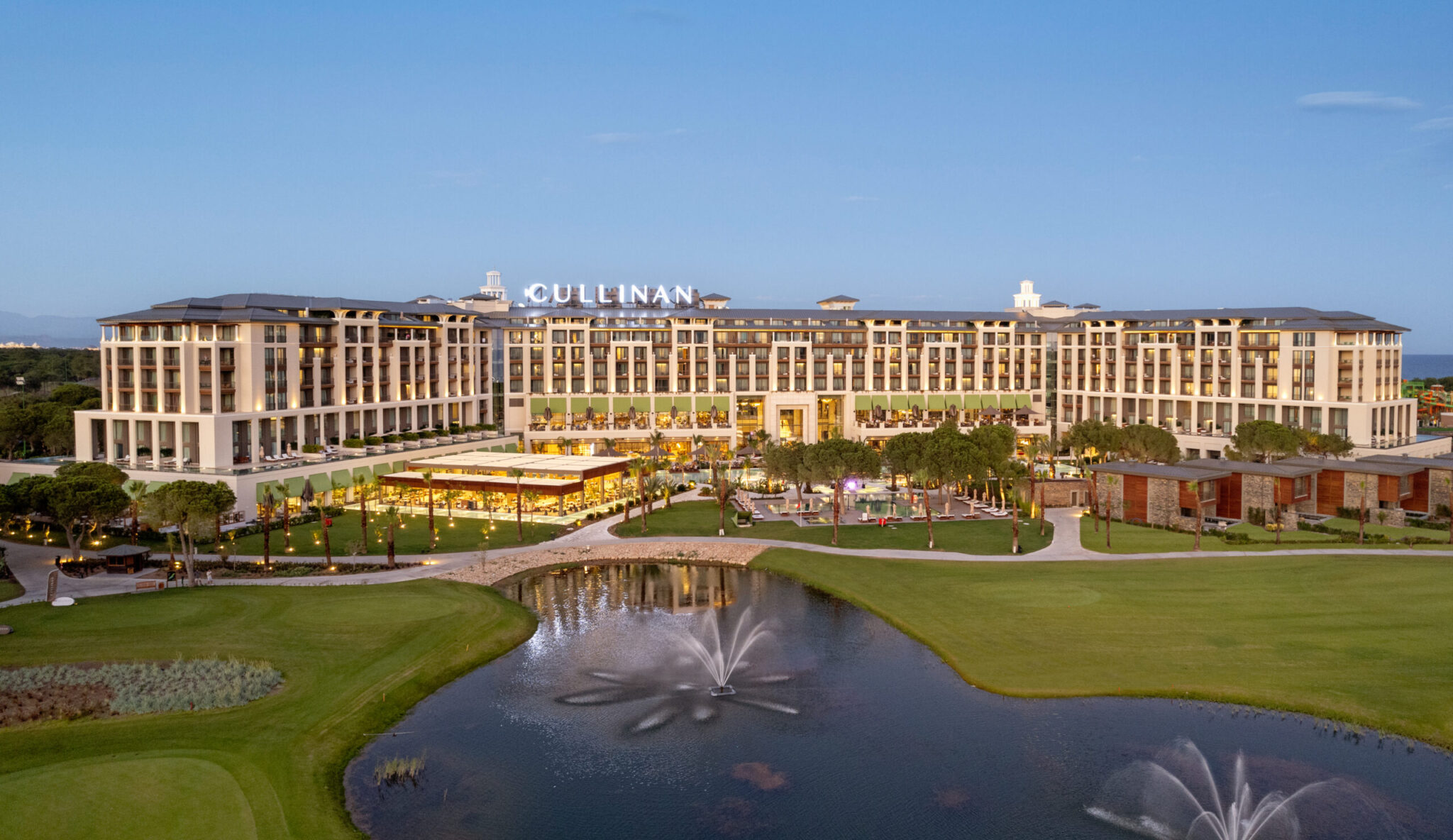 Cullinan golf course & lake views in the foreground with the grand looking Cullinan Belek Hotel in the background