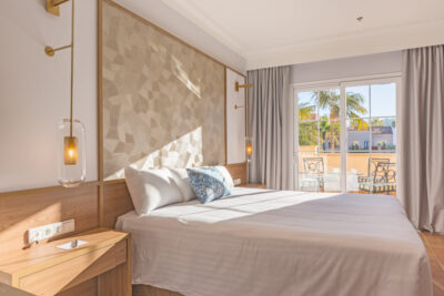 Double bed accommodation with doors leading to a private patio with chairs