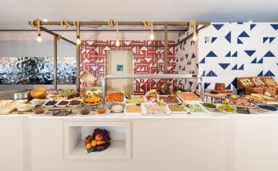 Breakfast buffet spread with a variety of meats, cheeses, fruits and pastries