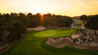 A beautiful view across the green at Dunas Comporta golf course with the sun in the background