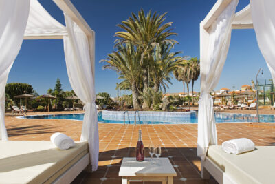 Elba Palace Golf Boutique Hotel seating area around the pool