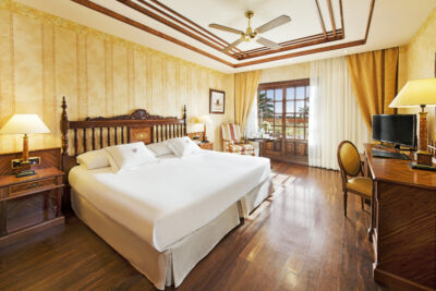 Elba Palace Golf Boutique Hotel bedroom with vanity & television