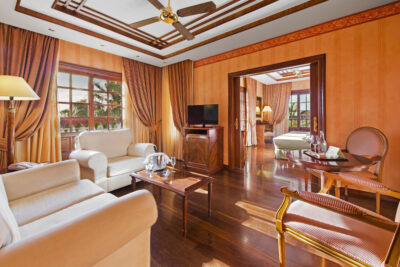 Elba Palace Golf Boutique Hotel lounge area in bedroom with television