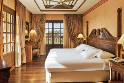 Elba Palace Golf Boutique Hotel bedroom with patio doors