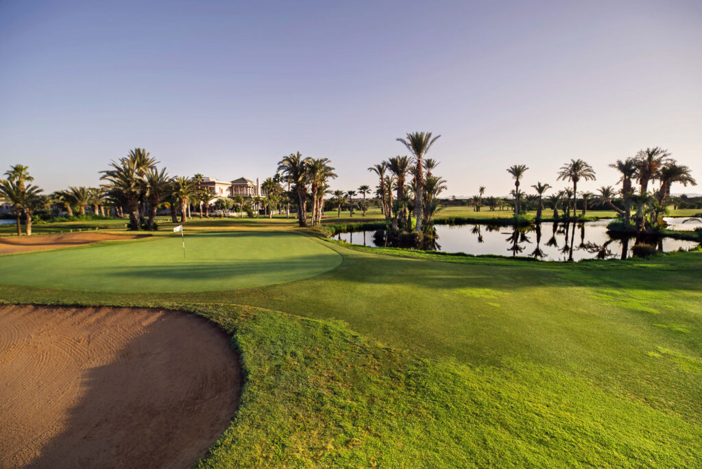 Greenside surrounded by lake on the right and a bunker at the front of the green at Golf Club Palmeraie