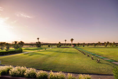 Driving range at Golf Club Palmeraiewith palm trees in distance
