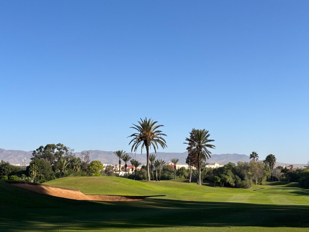 Fairway with bunkers on the left and palm trees in the distance at Golf du Soleil