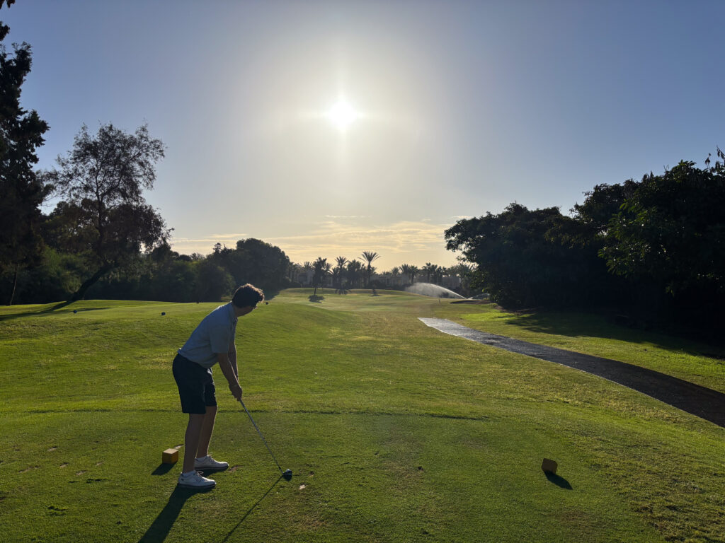 Tee box with man hitting iron at Golf du Soleil