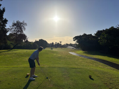 Tee box with man hitting iron at Golf du Soleil