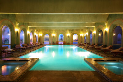 Indoor pool at Hotel du Golf Rotana with loungers
