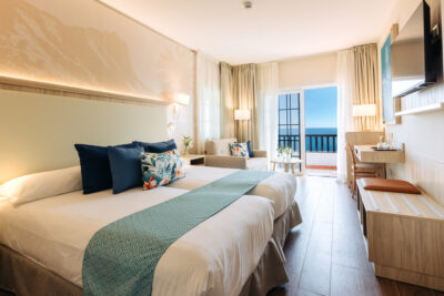 Double bed accommodation with seating area and a private balcony
