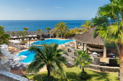 Outdoor pool at Hotel Jardin Tecina with a bar and view of the ocean
