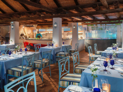 Restaurant with blue decor and an open kitchen