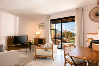 Hotel Villa Maria Suites lounge area with television