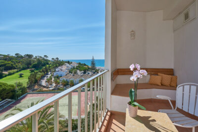 Balcony sitting area with a view of the tennis courts and surrounding areas