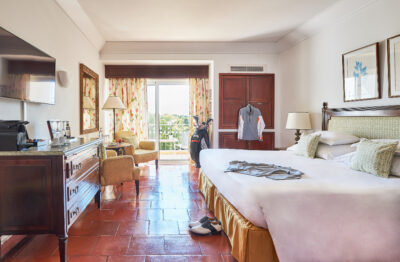 Double bed accommodation with golfing gear around the room