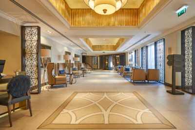 Lobby area at Dona Filipa Hotel with brown seats and blue cushions