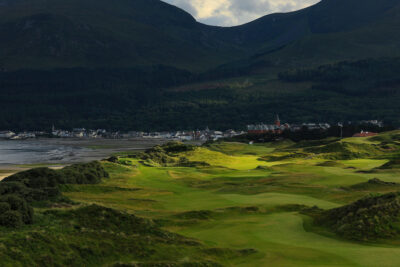 Fairway at Championship Links at Royal County Down with buildings in background