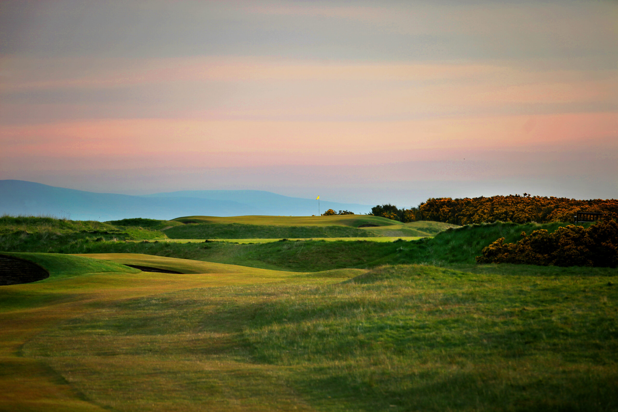 Hole with yellow flag at Royal Dornoch Golf Club - Championship Course