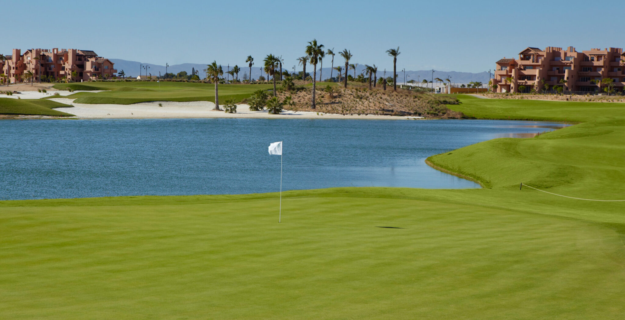A hole with a lake in background at Mar Menor Golf Course