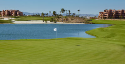 A hole with a lake in background at Mar Menor Golf Course