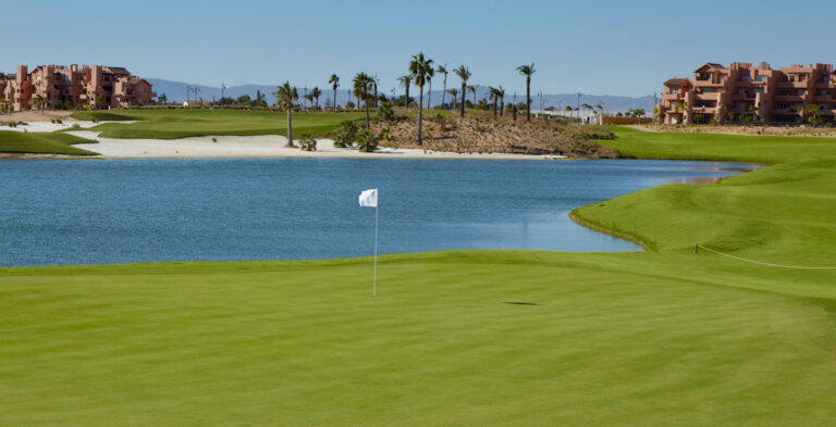 A hole with a lake in background at Mar Menor Golf Course