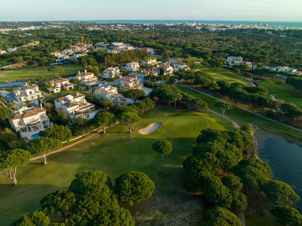 Aerial view of Vila Sol Golf Course with buildings around