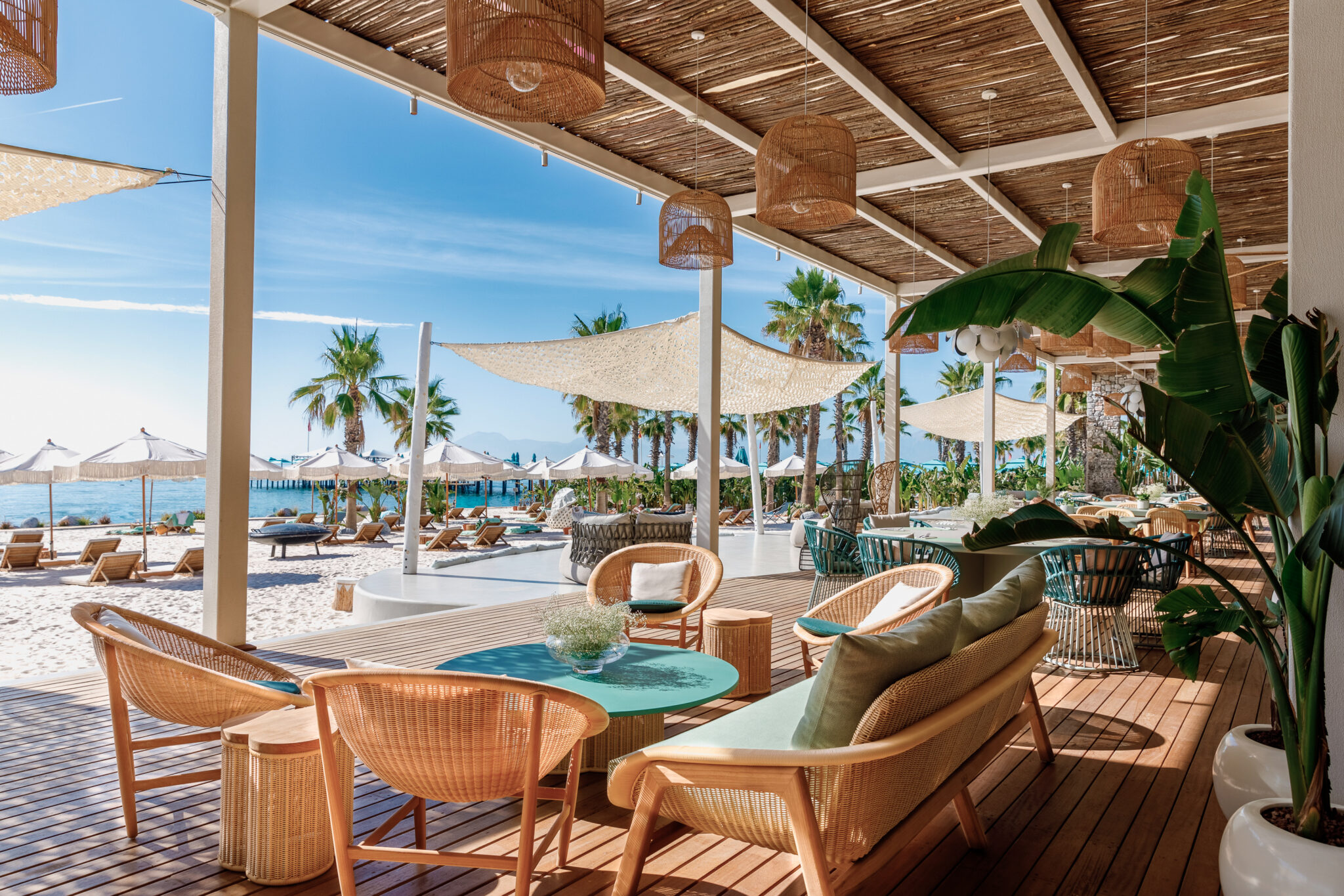 Outdoor seating area with beach view at Regnum Carya Golf & Spa Resort