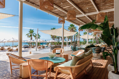 Outdoor seating area with beach view at Regnum Carya Golf & Spa Resort