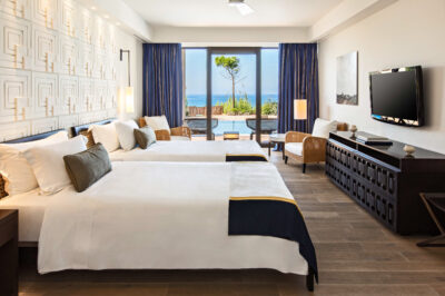 Twin bed accommodation at The Romanos Resort with private patio