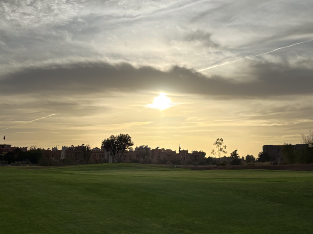 Green views with apartments in the background at The Montgomerie Marrakech