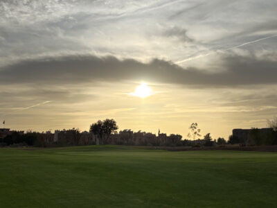 Green views with apartments in the background at The Montgomerie Marrakech