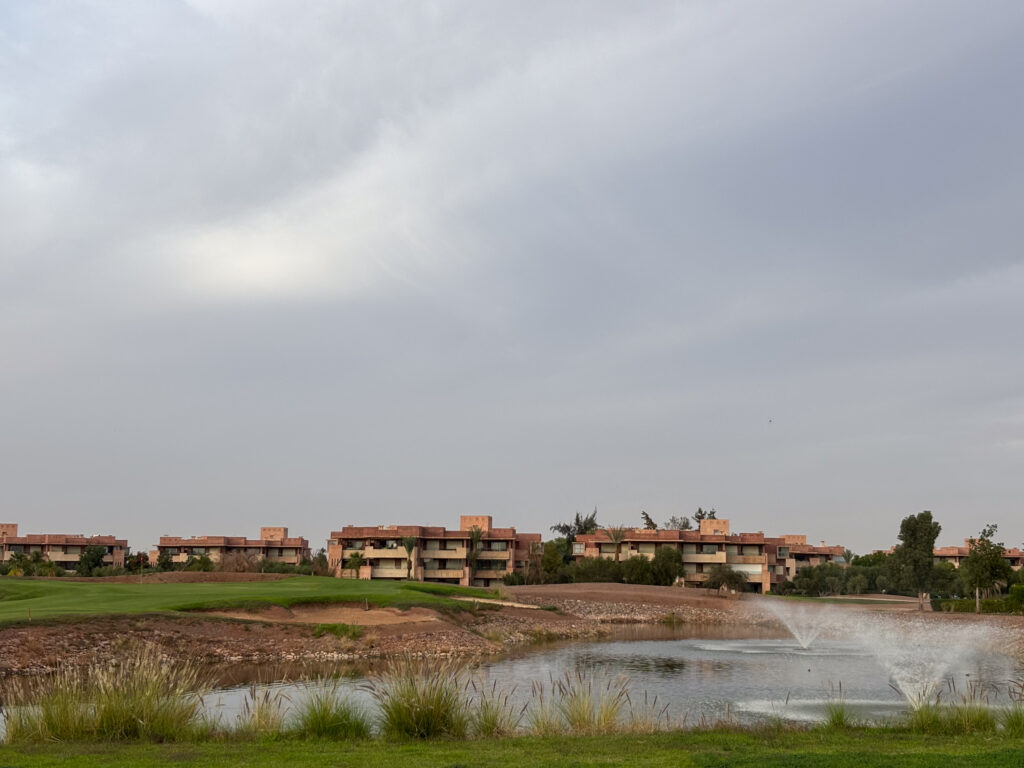 Two water fouantins alongside the fairway with aparmtents in the background
