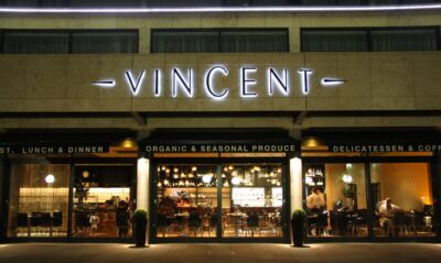 Exterior of The Vincent Hotel with windows looking into the restaurant