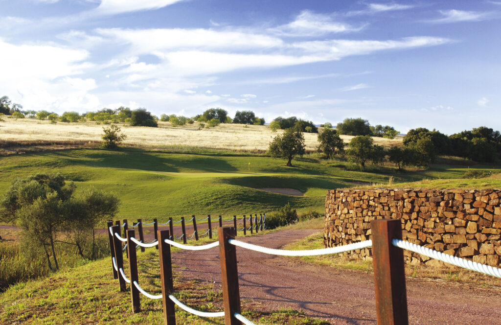 Path winding through the Alamos Golf Course with trees dotted around