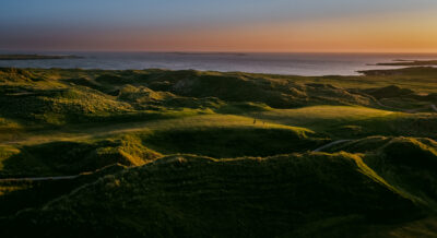 Aerial view of Carne Golf Links with ocean in distance
