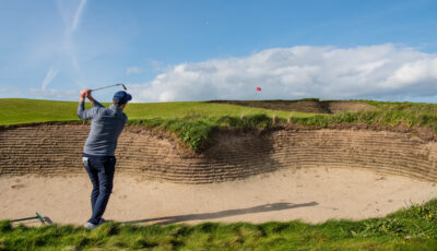 Person playing out of a bunker at Jameson Golf Links