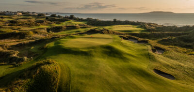 Hole with bunkers around at Jameson Golf Links with ocean in background