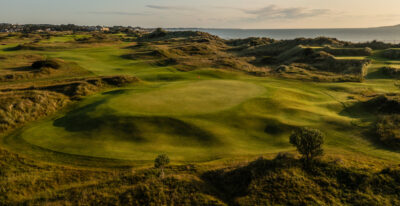 Hole at Jameson Golf Links with mounds around and ocean in background